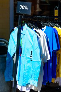 Simrishamn, Sweden - April 1, 2016: Shirts on an outdoor rack selling at 70 percent off.